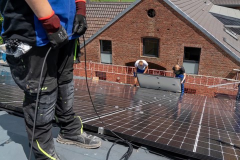 Installation of solar modules on the roof of a barn on a farm, over 210 photovoltaic modules are