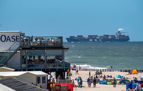 Beach of Domburg, in Zeeland, South Holland, Netherlands, in the background a container freighter