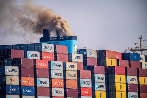Container freighter Madison Maersk smoking chimneys of the ship's diesel engines, Maasvlakte 2,