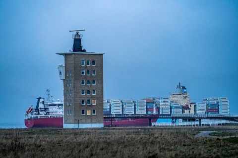 Thick fog in winter, hanging over the mouth of the Elbe into the North Sea, container ship Maersk