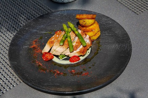 Tuna steak with green asparagus, fried potatoes served on a plate, main course, fish dish, Hotel