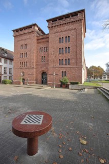 Proviant Magazin building built in 1867 with carnival museum, table with chessboard, Old Town,