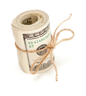 Roll of one hundred dollar bills tied with a jute string isolated on white background