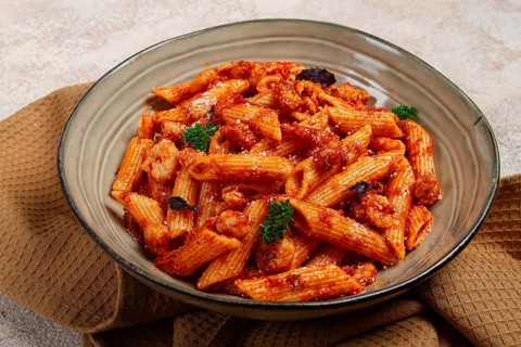 Penne pasta, with shrimp in tomato sauce, close-up, no people
