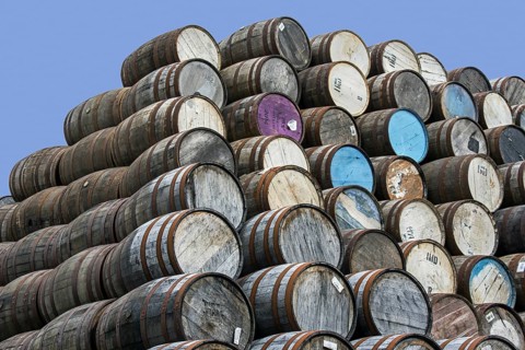 Huge stacks of discarded whisky casks, barrels at Speyside Cooperage, Craigellachie, Aberlour,