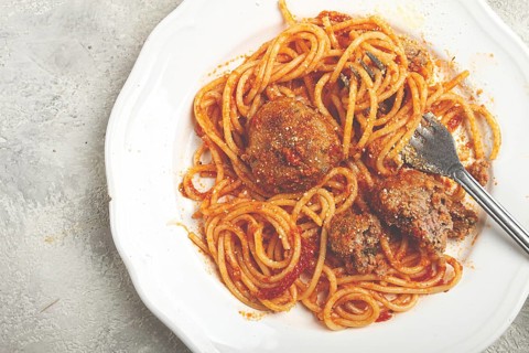 Spaghetti with meatballs in tomato sauce, on a white plate, no people, homemade