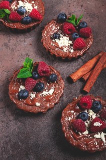 Chocolate tartlets, stuffed with cottage cheese and berries, breakfast, homemade, no people