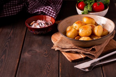 Fresh Cooked, new potatoes, with dill, on a wooden table, selective focus. close-up, toning, no