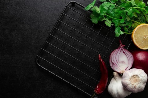 Food concept, black table, hot plate, spices, top view, no people horizontal