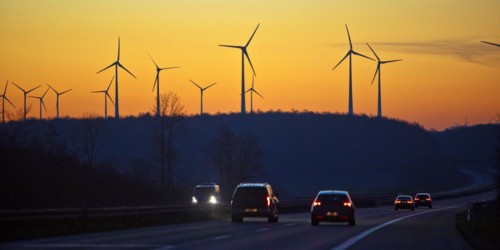 Wind turbines at sunrise with cars on the A 44 motorway, Büren, Paderborn plateau, North