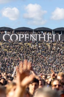 Copenhagen, Denmark - 19 June 2024: Festivalgoers in front of the logo at the Copenhell Metal