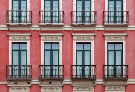 House façade with floor-to-ceiling windows and French balconies, Malaga, Andalusia, Spain, Europe