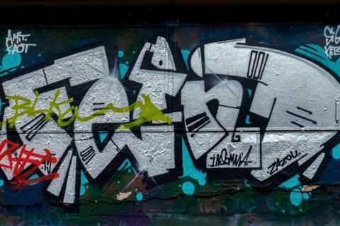 Black and white graffiti with green accents on a dark background, Landau, Rhineland-Palatinate,