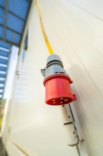 Close-up of a red socket on the outside wall of a container building, Beermiß refugee accommodation