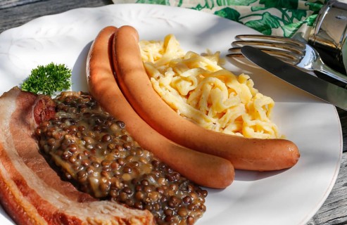 Swabian cuisine, lentils with spaetzle, pancetta and string sausages, meat arranged on a plate,