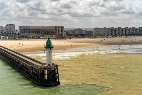 Lighthouse of the harbour entrance and beach of in Calais, France, Europe