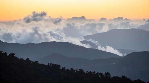 Dramatic clouds between the mountains at sunset, view over the cloud forestProvince of San José,