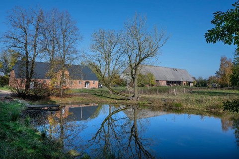 Othenstorf estate with former horse stable and large barn, built around 1900, in front the fire