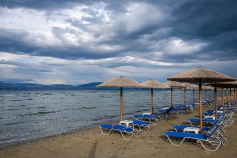 Kalamaki, Corfu, Greece, Sun loungers and parasols on Kalamaki beach in the north-east of the Greek