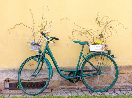 Bicycle decorated with flowers and Easter bunnies on a house wall, Sebnitz, Saxony, Germany, Europe