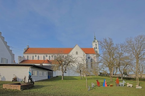 Monastery church of St Peter and Paul and nativity scene figures in the garden, monastery,