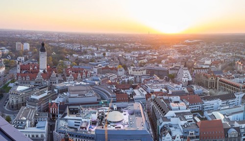 View of the city from the City Tower with evening sun, Neues Rathaus, Johannapark, Petersbogen and