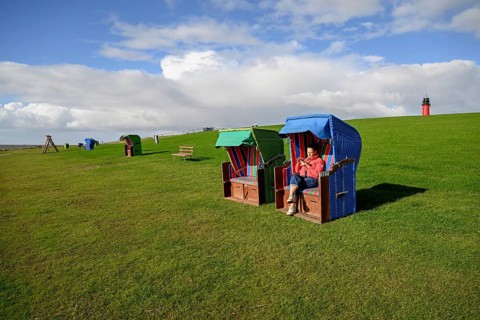Woman in a beach chair on the island of Pellworm, Wadden Sea National Park, North Frisia, Germany,