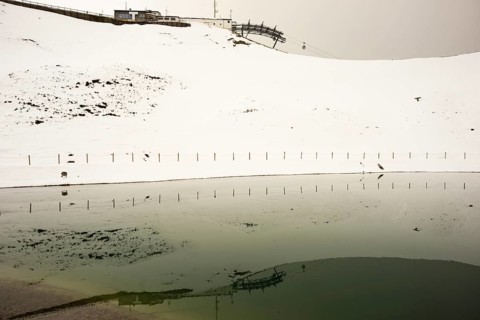 Onset of winter in May, Riezler Alpsee, an artificial lake, snow pond, feeds the snow cannons that