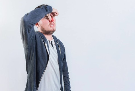 Suffering man with nasal bridge pain isolated. Guy suffering with nasal bridge on isolated
