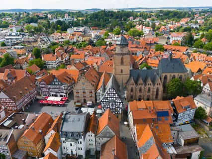 Aerial view of a historic town with half-timbered houses and a large church in the centre, aerial