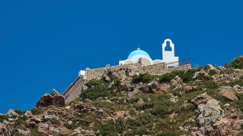 White-blue church on a rock under a clear blue sky, Church of Profitis Ilias, above Nikia, Nikia,