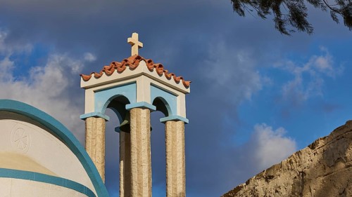 Saint Filimon church, detail of the church towers with a cross, blue sky in the background,