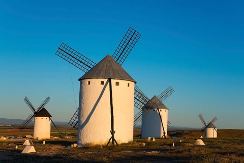 Four windmills in a sunny landscape panorama, Campo de Criptana, province of Ciudad Real,