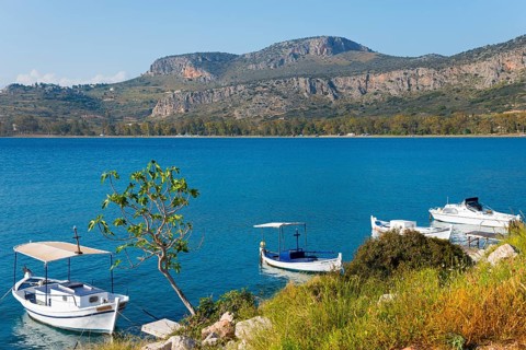 Sea view with several boats, surrounded by mountains in clear, sunny weather, Agia Kyriaki,