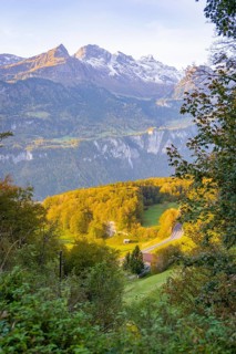 Panoramic view of alpine landscape with autumn forest and road in the valley, Lauterbrunnen,