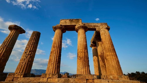 Archaic Temple of Apollo, Doric columns of a temple rise proudly under a bright blue sky,