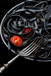 Black pasta coloured with squid ink on a plate, Taglioni al Nero di Seppia, Italy, Europe
