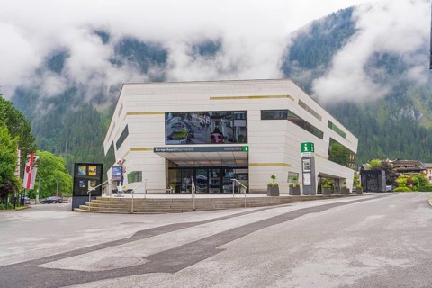 Modern building with large window front in foggy weather in the Alps, Mayrhofen, Zillertal,
