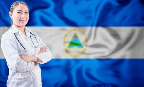 Doctor with crossed arms on Nicaragua flag background. Doctor with stethoscope on Nicaraguan flag.