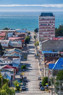 View from a hill over streets and houses to the Strait of Magellan, city of Punta Arenas,