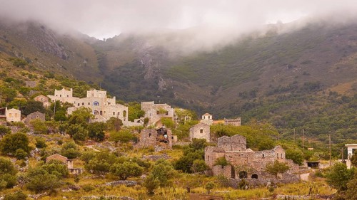 Village in the mist surrounded by mountains and greenery, Mani Peninsula, Peloponnese, Greece,