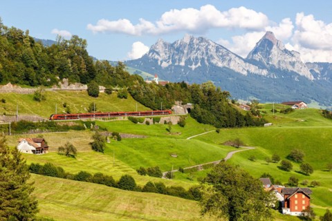 Railway passenger train of the type Stadler Flirt of the Südostbahn on the mountain Großer Mythen