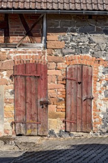 Historic farmhouse around 1800, half-timbered façade, sandstone, natural stone, brick, weathered