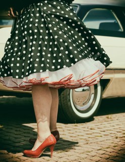 Vintage American road cruiser Buick with woman and petticoat