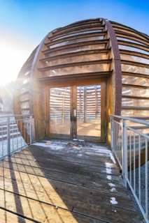 Close-up of an entrance to the wooden ball with decorative incidence of light and shadows, forest