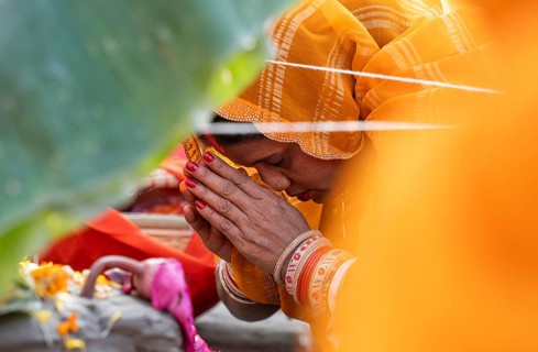 Hindu devotees perform rituals as they offer prayers to the Sun god in the bank of Brahmaputra