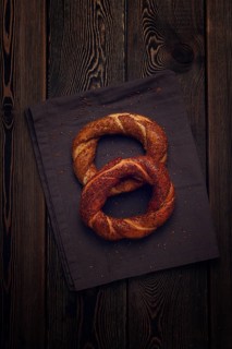 Traditional Turkish bagel Simit, Top view on a wooden table, vertical, no people, rustic style
