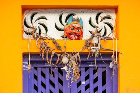 Purple-coloured front door, yellow wall, house entrance with demon mask, Rameswaram or Rameshwaram,