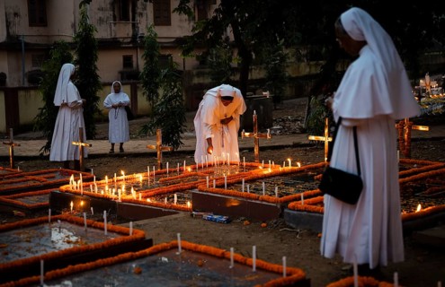 Nuns offer prayers on the grave during the All souls day observation, in Guwahati, India on 2
