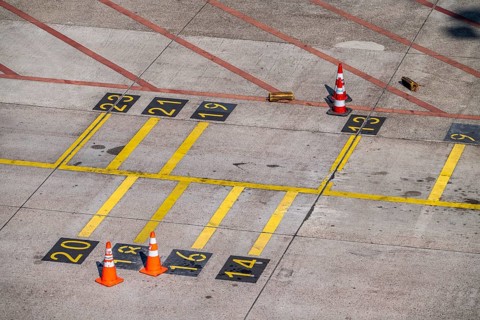 Park markings on the ground, at the terminal, in front of the passenger boarding bridge, holding